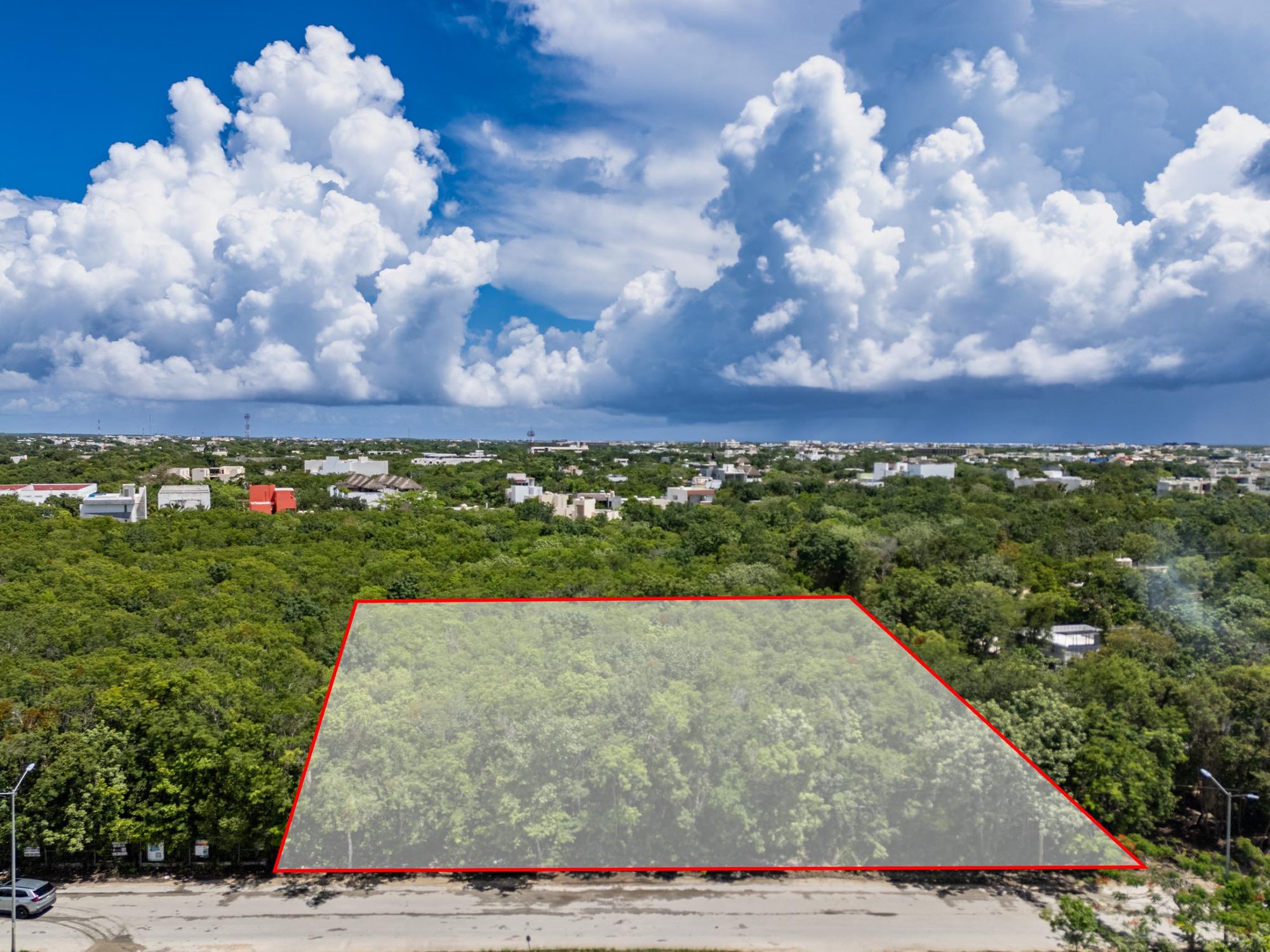 Drone view with the lot boundary outlined in red along the street