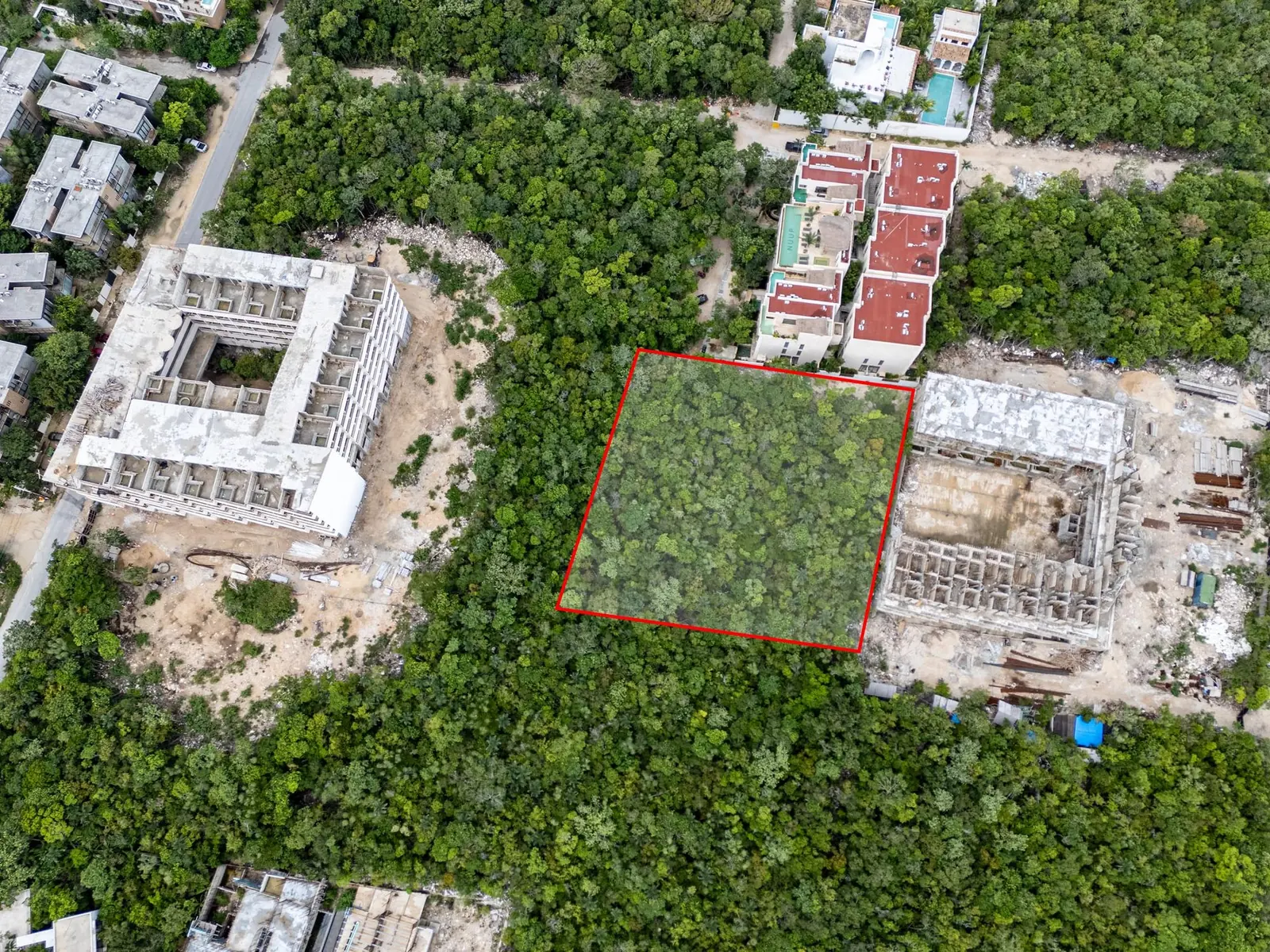 Top-down drone view with Lot 644 outlined in red between two residential buildings